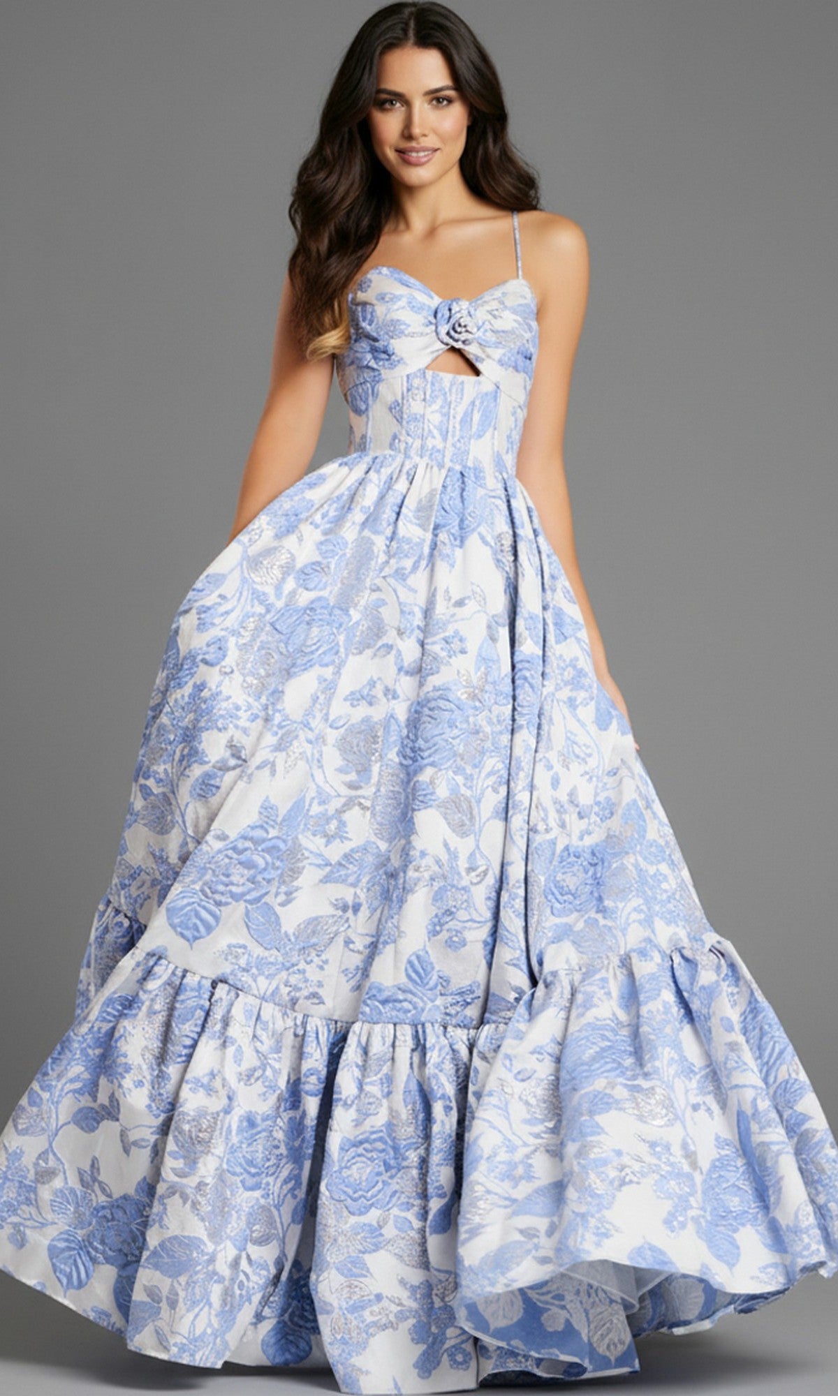 A woman wearing the Jovani 47328 long prom dress in light blue, featuring a sleeveless corset bodice with a cutout detail and a full, ruffled skirt.